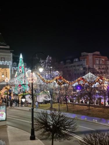 a city lit up at night with christmas lights at Apartament ultracentral Classic Vibe in Craiova