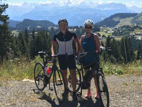 two women standing next to their bikes on a mountain at Chalet Serein in Seytroux
