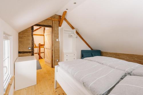 a bedroom with two beds and a blue chair at Alte Schreinerei in Monschau