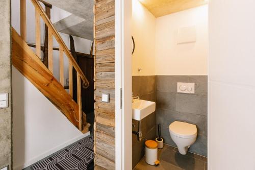 a small bathroom with a toilet and a staircase at Alte Schreinerei in Monschau