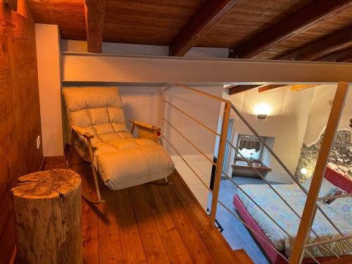 a small room with a bed and a staircase at Le Relais du Bourg Chambres de charme Wellnes in Donnas