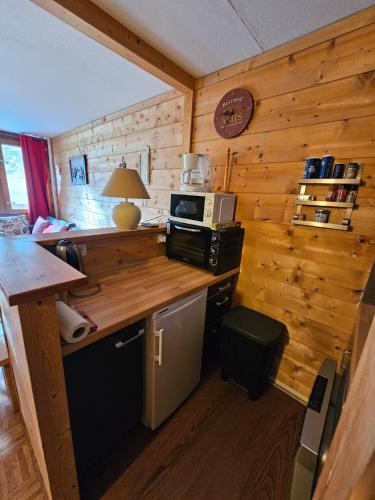 - une cuisine avec un comptoir et un four micro-ondes dans une cabine dans l'établissement Appartement au pied des pistes La Mongie Tourmalet, à Bagnères-de-Bigorre