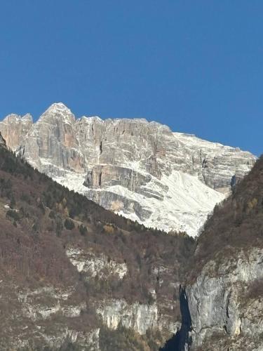 a mountain with snow on the side of it at Appartamento Bosco al Sole in San Lorenzo in Banale