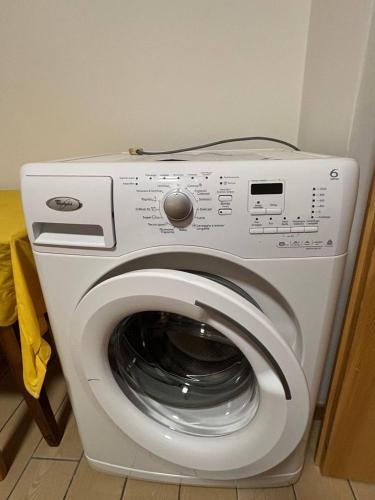 a white washing machine sitting in a room at Appartamento Bosco al Sole in San Lorenzo in Banale