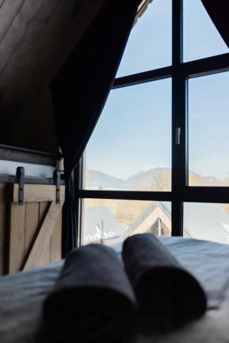 a bed in a room with a large window at Bobrí potôčik in Liptovský Mikuláš