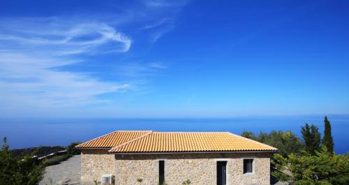 a building with a tile roof on top of it at Point of View Andromeda in Drymon