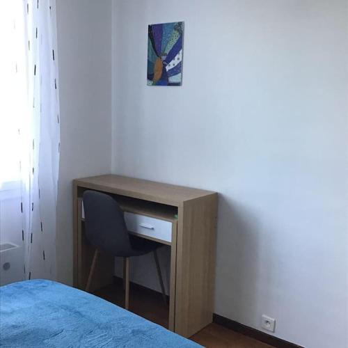 a desk with a chair next to a bed at Le Gîte de Mellonia - 7 chambres in Pouzauges