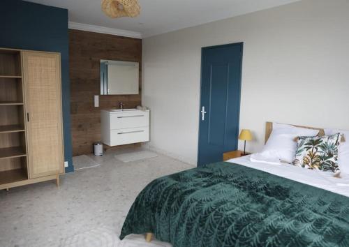 a bedroom with a large bed and a sink at Le Gîte de Mellonia - 7 chambres in Pouzauges