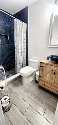 a bathroom with a toilet and a shower at Heart of Tampa in Tampa
