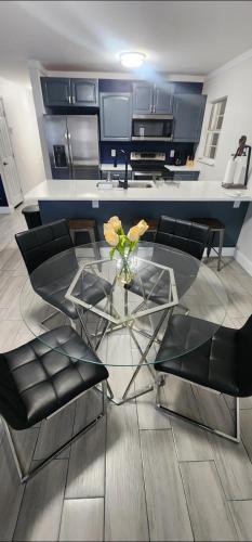 a living room with a glass table and chairs at Heart of Tampa in Tampa