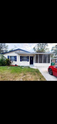 a house with a red car parked in front of it at Heart of Tampa in Tampa