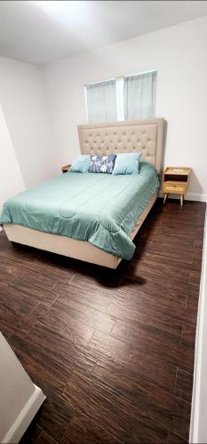 a bed in a bedroom with a wooden floor at Heart of Tampa in Tampa