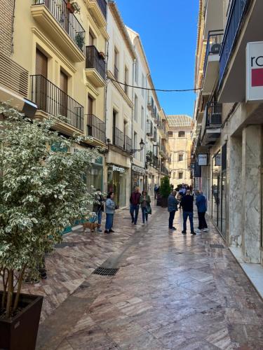 a group of people walking down a street at Apartamento Trébol in Antequera