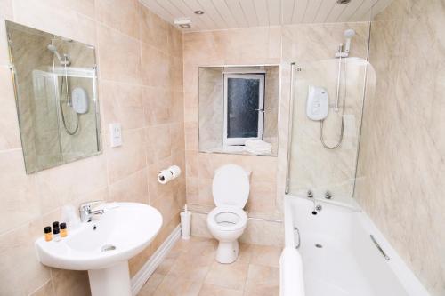 a bathroom with a toilet and a sink and a shower at Douglas Arms Hotel in Banchory