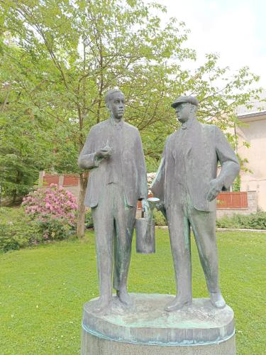 a statue of two men standing next to each other at Chaloupka pod lípou in Malé Svatoňovice