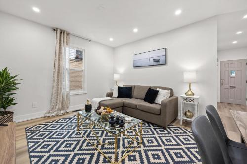 a living room with a couch and a table at Private House with parking & steps to subway in Toronto