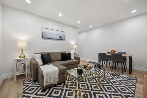 a living room with a couch and a table at Private House with parking & steps to subway in Toronto