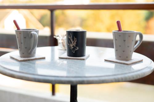 three coffee mugs sitting on a table at 3 Minuti da Asiago - Zona Tranquilla e Silenziosa in Gallio