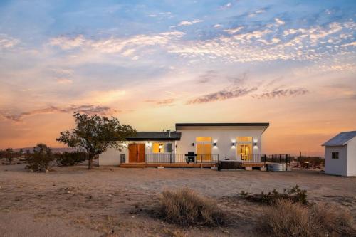 a small house in the middle of a field at Shangrila By The Cohost Company in Joshua Tree