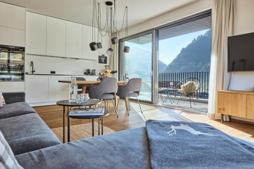 a living room with a couch and a table at Stilvolles, lichtdurchflutetes Luxus-Appartement in der Residenz Silvretta - Inklusive Silvretta Card Premium in See
