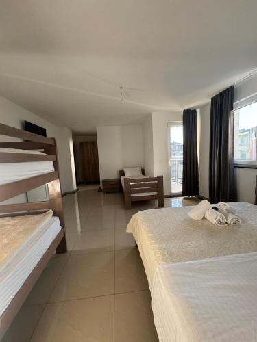 a hotel room with two beds and a couch at Hotel Palace Struga in Struga