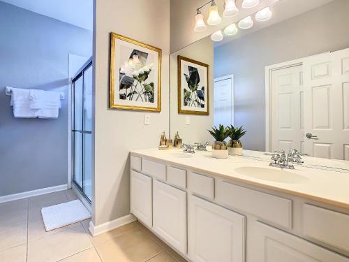 a bathroom with a sink and a mirror at WH7820BS - 5 bedrooms - Pool - Theater - Resort in Orlando
