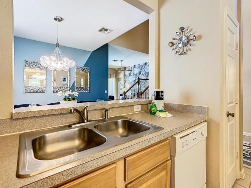 a kitchen with a stainless steel sink and a mirror at WH7742CS - Newly renovated villa in Windsor Hills in Orlando
