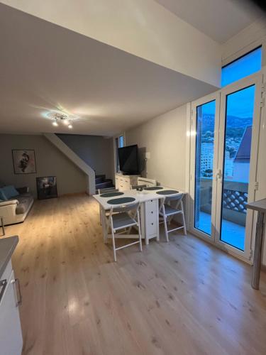 un grand salon avec un bureau et une télévision dans l'établissement Duplex à la frontière de Monaco, à Beausoleil