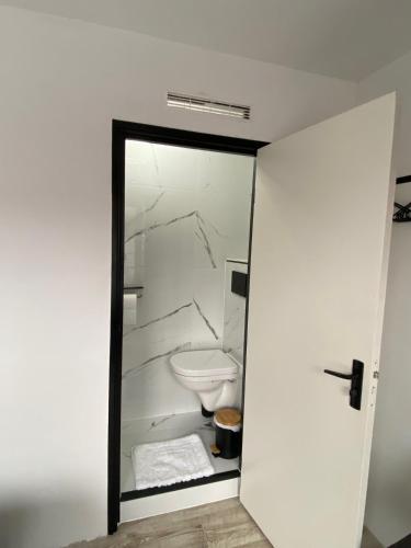 a white bathroom with a toilet in a room at Amsterdam Soul Inn in Amsterdam