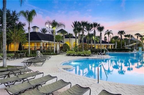 a swimming pool with chairs and a resort at WH7820BS - 5 bedrooms - Pool - Theater - Resort in Orlando