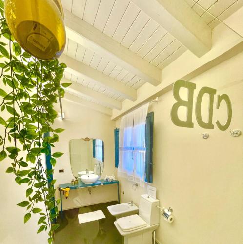 a bathroom with a toilet and a sink and a mirror at Casale Di Benedetto in Caltagirone