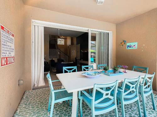 a dining room with a table and blue chairs at WH7742CS - Newly renovated villa in Windsor Hills in Orlando