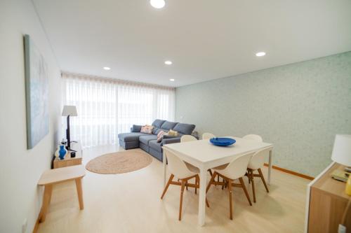 a living room with a table and a couch at Apartamento Lux 1882 in Figueira da Foz