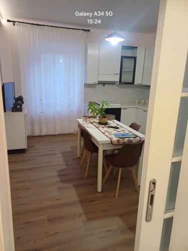 a kitchen with a table and chairs in a room at Il paradiso sotto le nuvole in Peccioli