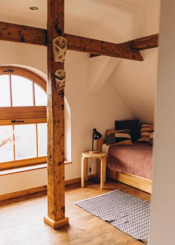 a bedroom with a bed and a large window at Villa Hubertus in Srebrna Góra