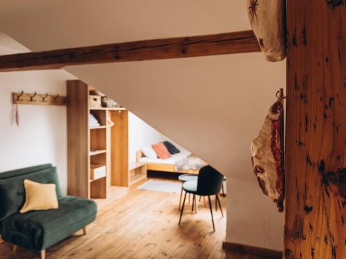 a living room with a green couch and a bunk bed at Villa Hubertus in Srebrna Góra