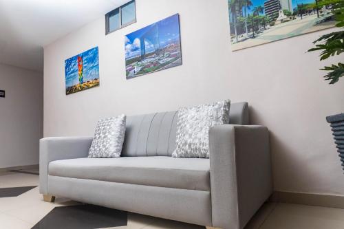 a living room with a couch and pictures on the wall at HOTEL DASANTO HD in Barranquilla