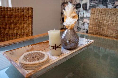 a table with a candle and a vase on it at Ferienwohnung am Bismarckturm in Bodenwerder