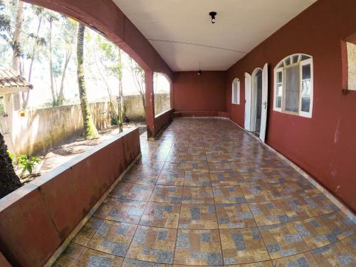 an empty hallway of a building with a tile floor at Refúgio da Ilha in Ilha Comprida