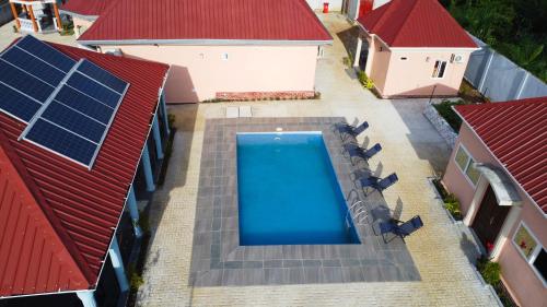 an overhead view of a swimming pool on a house with red roofs at Africa Waka Waka Resort in Lungi