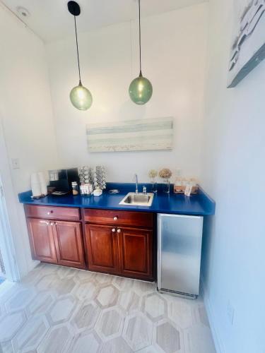 a kitchen with a sink and two pendant lights at Windward at the Beach in Beach Haven