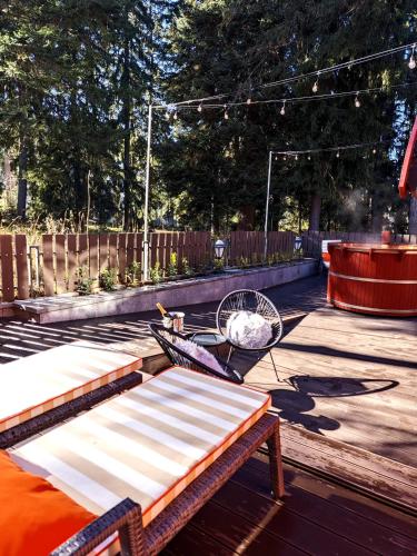 a wooden deck with a bench and a table at Villa Sokol in Borovets