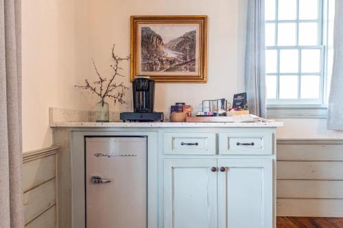 a kitchen with a white counter and a refrigerator at The Mohawk Valley House - 4 suite boutique hotel renamed in Bellmead