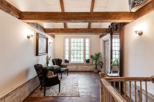 a hallway with a table and chairs in a house at The Mohawk Valley House - 4 suite boutique hotel renamed in Bellmead