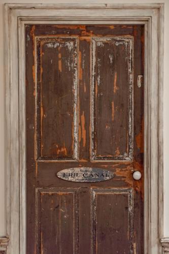 an old wooden door with a sign on it at The Mohawk Valley House - 4 suite boutique hotel renamed in Bellmead