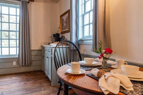 a dining room with a wooden table and chairs at The Mohawk Valley House - 4 suite boutique hotel renamed in Bellmead