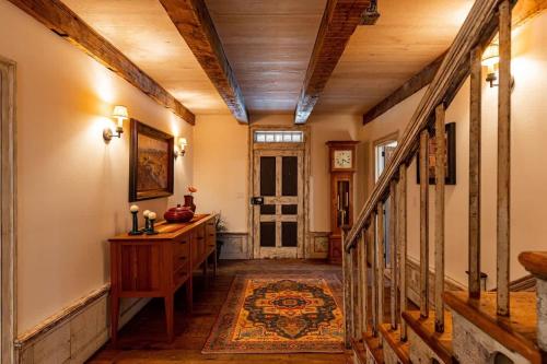 a hallway with a staircase with a wooden ceiling at The Mohawk Valley House - 4 suite boutique hotel renamed in Bellmead