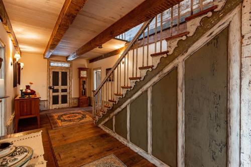 a hallway with a staircase in a house at The Mohawk Valley House - 4 suite boutique hotel renamed in Bellmead