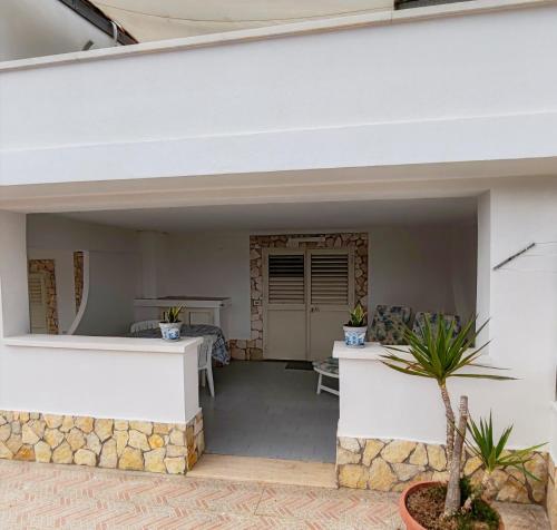 a patio of a house with a table at La Pergola Apartments in Lampedusa