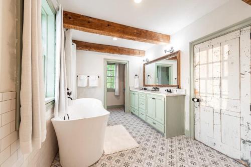 a bathroom with a large tub and a sink at Hudson upstairs suite - The Mohawk Valley House in Bellmead